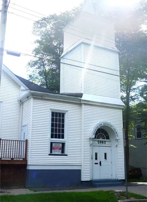 The white wooden church building on Parker Street where CRPC meets